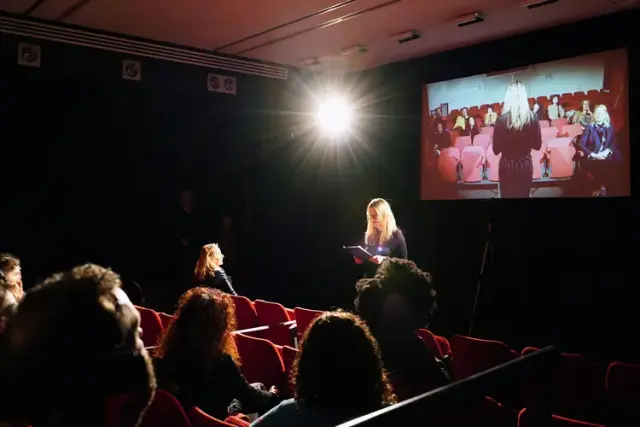 “Dividing the audience into Chinese and Japanese in Glasgow”. Performer, audience, partitions, video camera, projector. Performer: Sacha Carr. 2019. Centre for Contemporary Arts, Glasgow